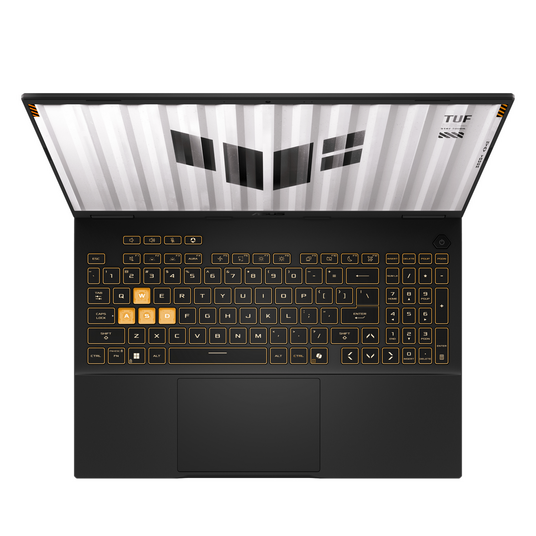 Un portátil negro desde arriba con teclado iluminado en amarillo. La pantalla muestra un logotipo blanco.